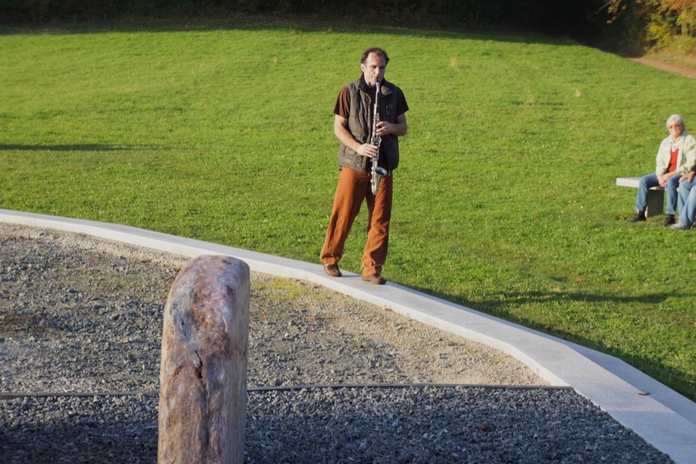 Hine Ma Tov Uma Na'im on the saxophone while walking around the Memory of Peace Circle